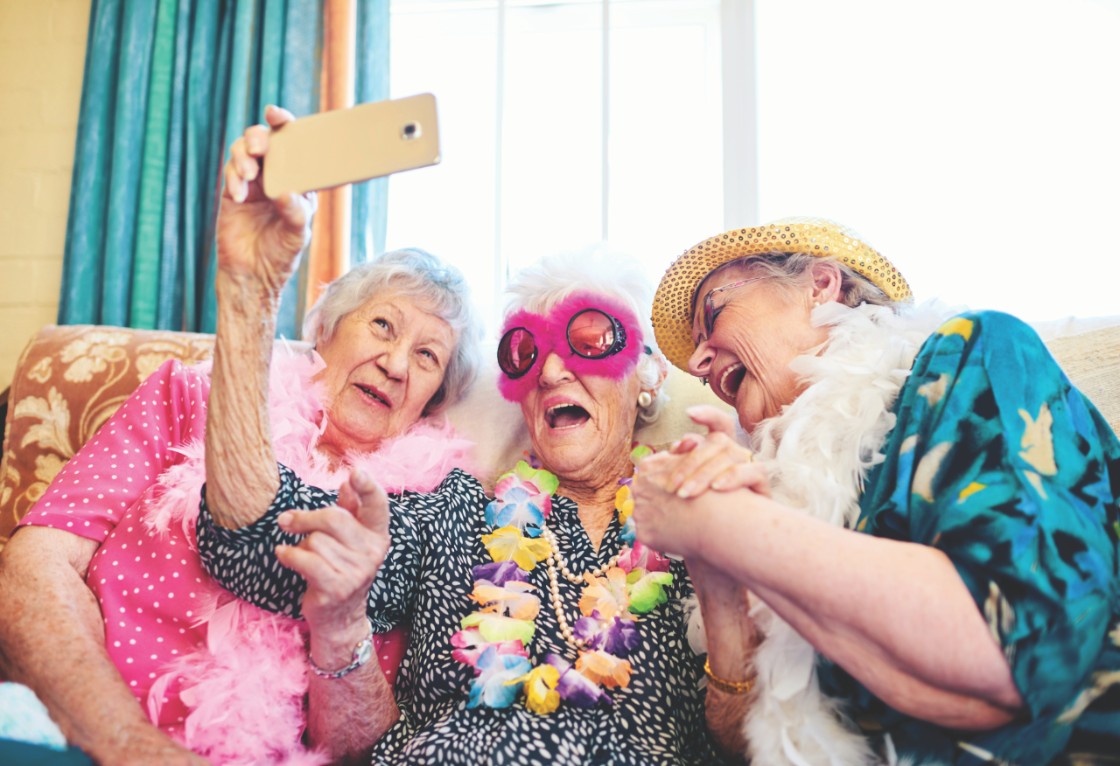 Community friends with fun outfits taking selfie picture with iphone