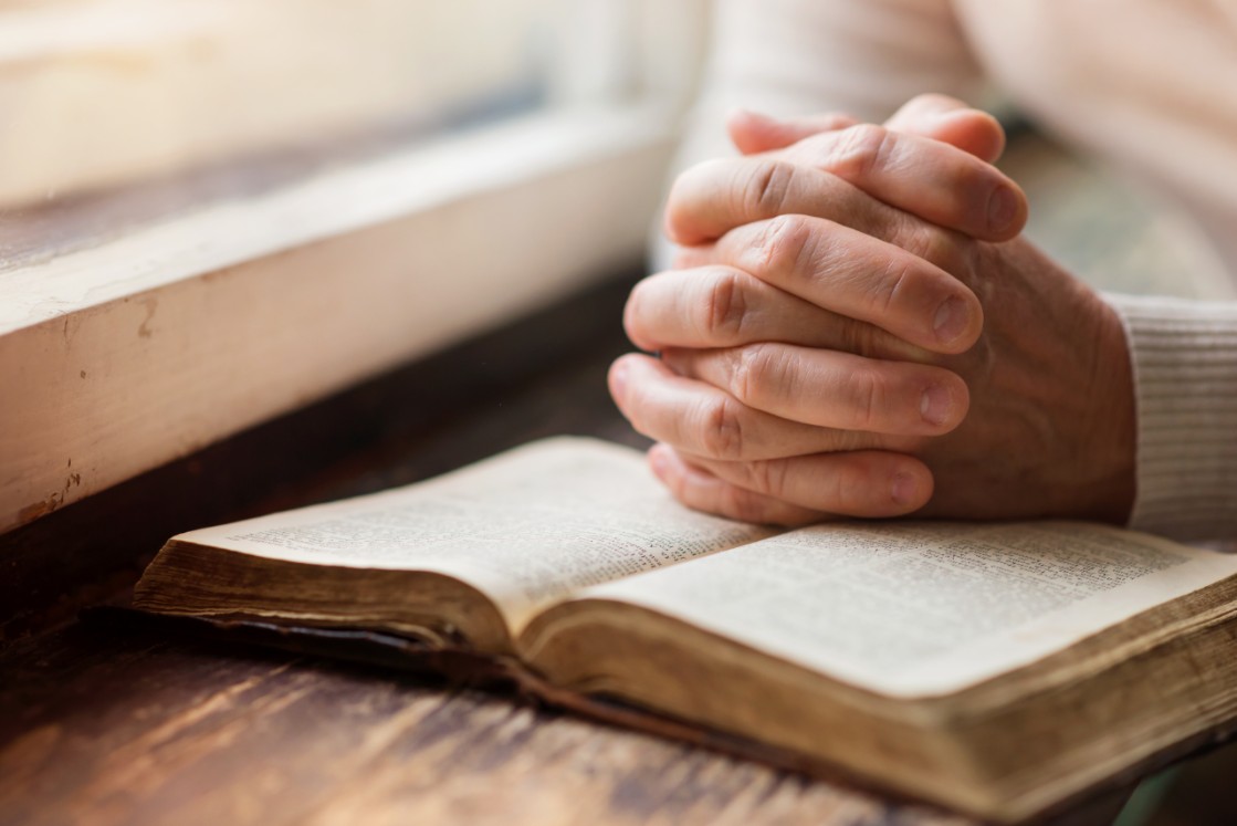 Hands clasped in prayer